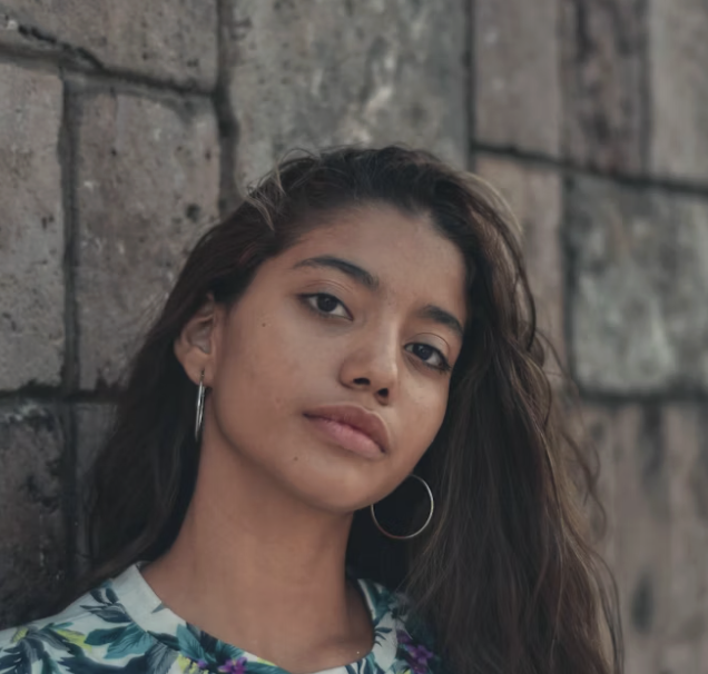 Woman against stone wall